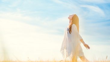 Happy young woman in a field